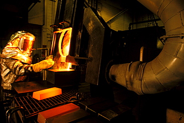 Refiner Tim Higgins pours eight 50 pound bars of 85% gold at the Newmont Carlin, Nevada, gold mine.