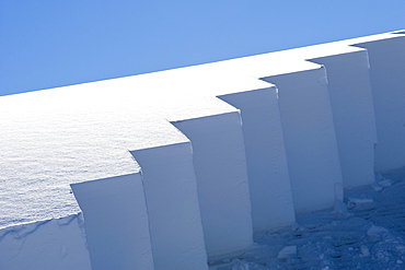 Snow on a building roof being sawed off on February 15, 2008 to reduce the snow load in Yellowstone National Park, Wyoming.