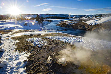 Steam rising from a thermal pool at sunset on February 15, 2008 in Yellowstone National Park, Wyoming near Old Faithful.