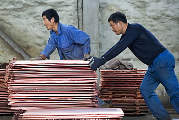 Chinese workers labor at a copper smelter in Tongling in China's central Anhui Province. The smelter refined some of the metals that will be used in the 2008 Summer Olympic medals to be held in Beijing.