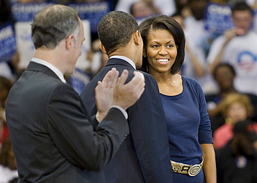 Senator Barack Obama whispers to his wife, Michelle Obama, while Senator Bob Casey watches at the Peterson Event Center in Pittsburgh, Pennsylvania, the night before the PA primary.