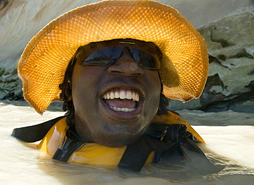 A boy floats down the Dolores River while on a rafting outing in Mexican Hat, Utah, United States.