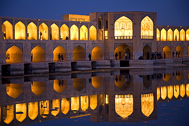 Esfahan, Iran - February, 2008: Khaju Bridge in Esfahan, Iran spans the Zayandeh River and is a popular hangout for locals in the evening.