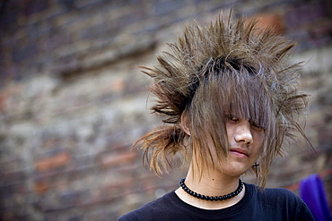 Young hairdressers show off their unique hairstyles as they wait for customers in a salon in the town of Longyan in southern China's Fujian Province.