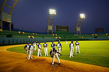 Havana's baseball team, the Industriales, warm up at Estadio Lantinoamericano, the main baseball stadium in Havana, Cuba.