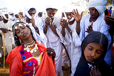 Shanabla men dance and chant at a wedding celebration near El Obeid, Sudan. A nomadic tribe they raise camels.