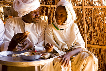 Camel traders and herders sit in a tea hut in a camel market in El Obeid, Sudan