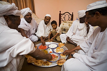 Sayyid Abdelbagi at home in El Obeid, Sudan (fourth from right) celebrating the purchase of camels that will go to Egypt.