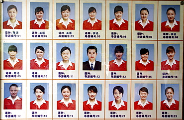 A sign shows the photos of tour guides at a tourist site in Guilin, China.