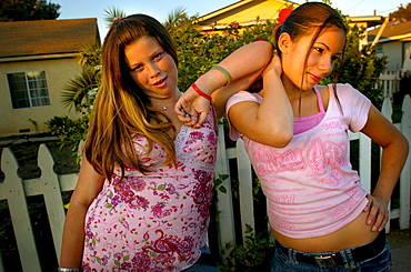 Teenage girls pose on Ramona Street in Ventura, California.