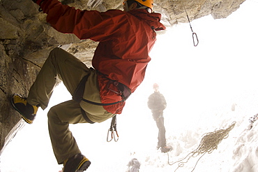 A man is belayed while rock climbing.