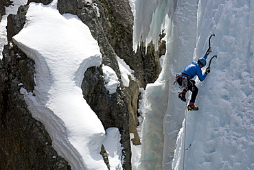 A woman ice climbing in the Ouray Ice Park, Ouray, Colorado.