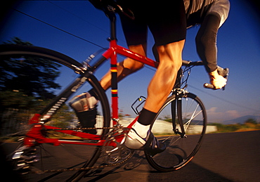 A cyclist races by and is photographed from a low angle near Eunumclaw, Washington.