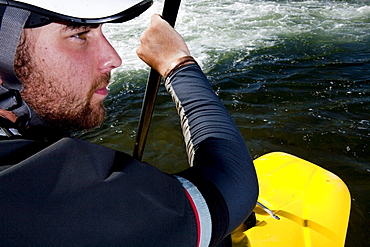 Close-up of a kayaker's face while paddling the Clark Fork River, Missoula, Montana.