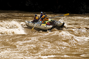 Rubber rafts row downstream during a whitewater rafting trip in Western China.