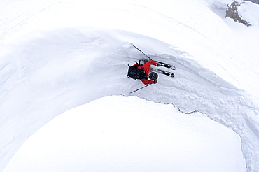 A man skiing next to a rock in Jackson Hole, Wyoming.