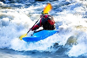 A male kayaker battles rapids on the Clark Fork River, Missoula, Montana.