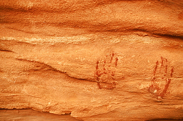 Anasazi hand paints on sandstone wall in cave, Natural Bridges National Monument, UT.