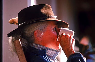 Woman relaxing, sipping coffee in the Patagonia, Argentina.