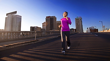 A teenage girl runs downhill on a street in downtown Birmingham, Alabama.