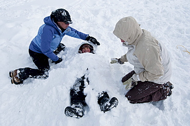 A young boy gets buried in the snow in Incline Village, Nevada.