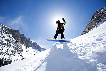 A boy snowboarding in the California backcountry.