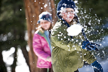 A boy and girl enjoy a snowball fight in Lake Tahoe, California.