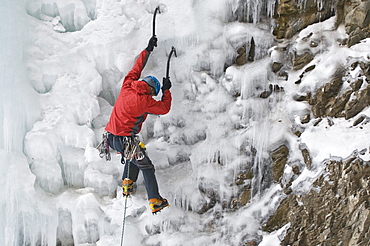 A man ice climbing a  frozen waterfall called Whorehouse Ice Hose, Silverton, Colorado.