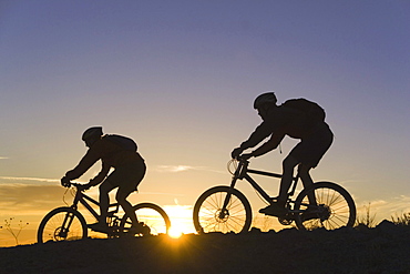 Mountain biking at sunset in California.