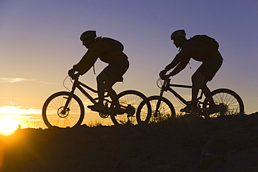 Mountain biking at sunset in California.