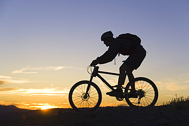 Mountain biking at sunset in California.