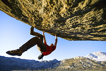 Man bouldering on an overhang