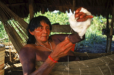 Tirio Indian woman spinning thread in Kwamalasamutu in southern Suriname.