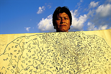 Tirio Indian Wuta Wajimuu holds a freehand map he drew of his people's area in southern Suriname. Bows and arrows indicate good hunting areas, etc.