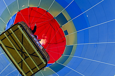 Hot air balloons lift skyward. The Albuquerque International Balloon Fiesta takes place in Albuquerque, New Mexico each year drawing in participants and spectators from across the globe. Highlights include an early morning dawn patrol, followed by mass ascencion of aircraft and an evening glow which all take place at the Balloon Fiesta Park throughout the week long event.