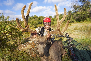 Bow Hunter with red bandana poseing with his trophy, Pagosa Springs, CO, USA