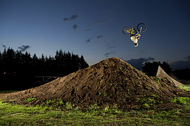 A young man performs a backflip jump in his backyard dirt track near the city of Toluca, Mexico