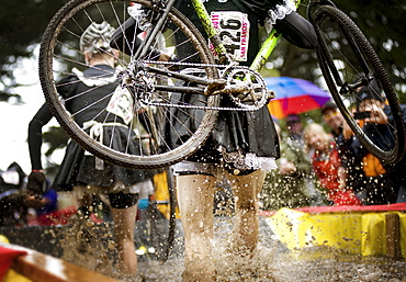 cyclocross racer steps through water obstacles...San Francisco, California