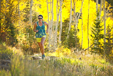 Woman running on a trail in Park City, Utah.