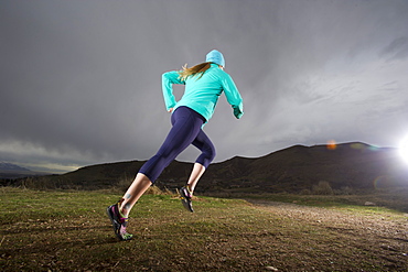 Woman runs in the Marin headlands in California.