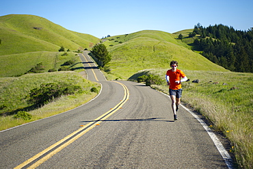 Man runs trails in the Marin Headlands in California.