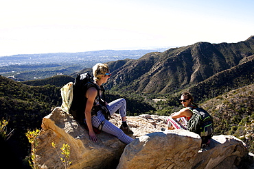 Two female climbers talk after climbing on Lower Gibraltar Rock in Santa Barbara, California