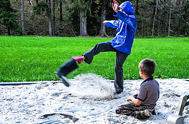 A girl kicks sand out from her boot at Laurel Hill State Park PA