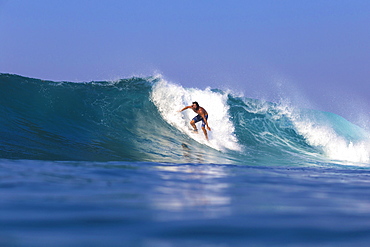 Surfer with a board in the water. West Sumbawa.Indonesia.Indonesia