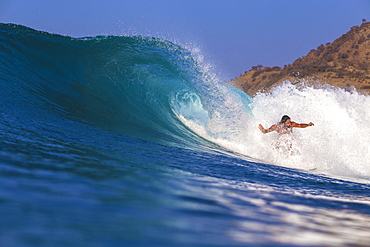 Surfer with a board in the water. West Sumbawa.Indonesia.Indonesia