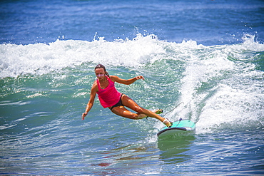 Surfer girl catches wave in high heels.