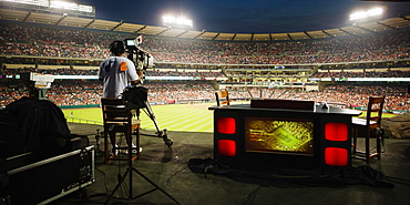 Rear view of a cameraman at a professional baseball game at Angel Stadium of Anaheim, California. USA.