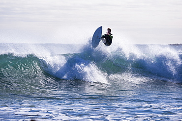 A surfer catching some air at Marrawah on Tasmania's rugged West Coast.