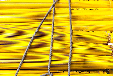 Close up of a stack of yellow closed umbrellas, Japan.