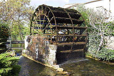 TheTourelles water wheel was constructed by royal decree in 1832 and still turns today. One of 14 in the busy market town of L'Isle-sur-la-Sorge in the Luberon district of Provence, France, it once powered the town's factories for corn and cloth.